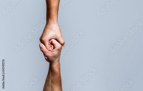 Helping hand outstretched, isolated arm, salvation. Close up help hand. Helping hand concept and international day of peace, support. Two hands, helping arm of a friend, teamwork