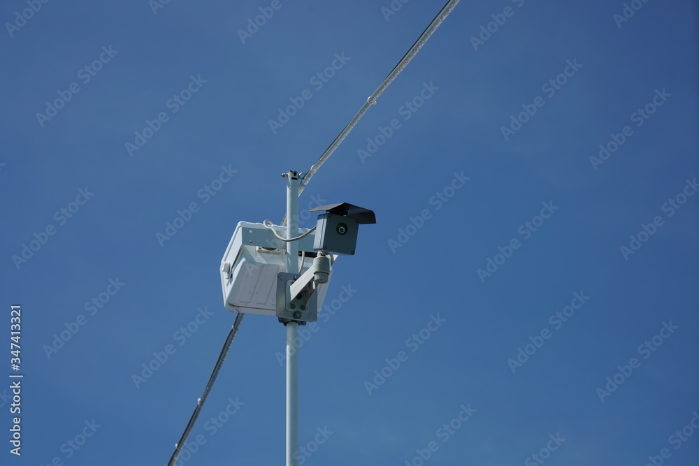 Security camera for on an antenna mouse the blue sky Security camera for on an antenna mouse the blue sky