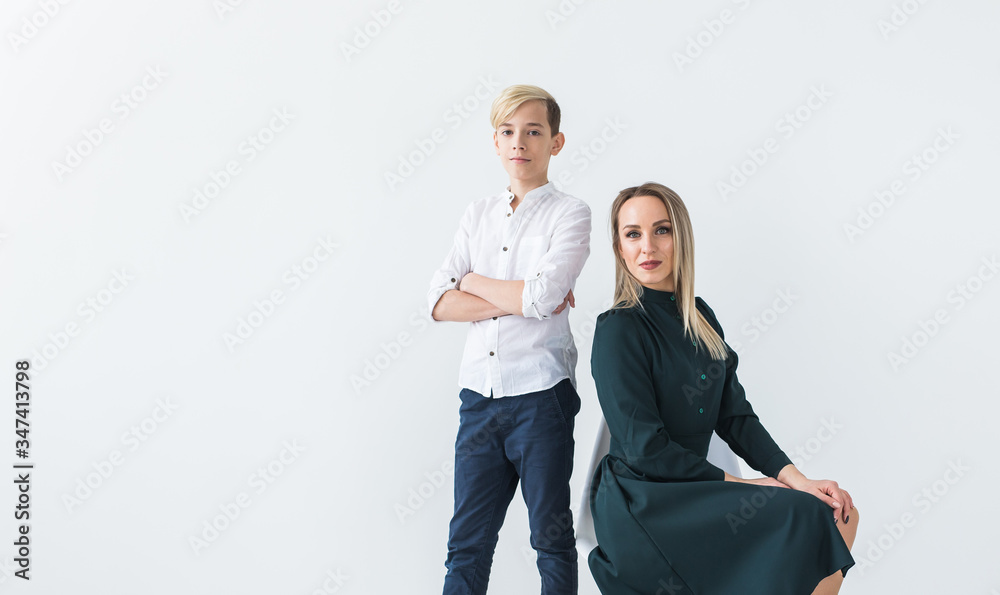 Teenager and single parent - Young mother and son together on white background.