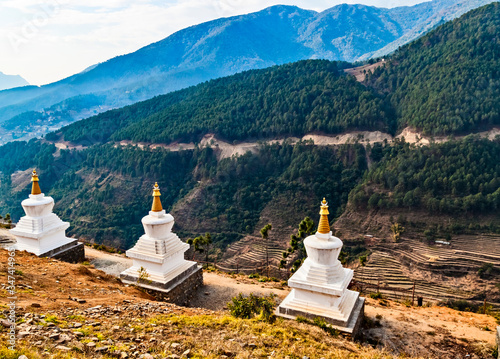 Small buddhist tower-shaped Stupa on background of Himalaya mountains in Bhutan, Asia