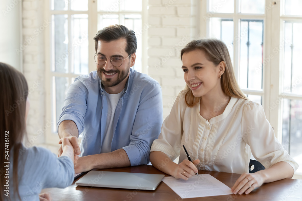 Smiling employers shake hand greet get acquainted with female job candidate at interview in office, happy recruiters handshake close deal with applicant after successful meeting, recruitment concept Smiling employers shake hand greet get acquainted with female job candidate at interview in office, happy recruiters handshake close deal with applicant after successful meeting, recruitment concept