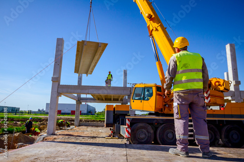 Boss oversees, control managing concrete joist for assembly huge concrete construction photo