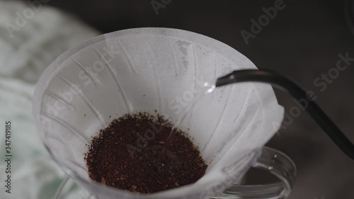 Coffee Drip Concept. Pouring Hot Water from Kettle into a Drpper. Blooming Process. Making Hot Coffee Drink in House. Zen and Cozy Living. Top View