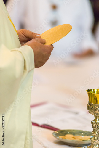 Fototapeta Midsection Of Priest Standing By Table In Church