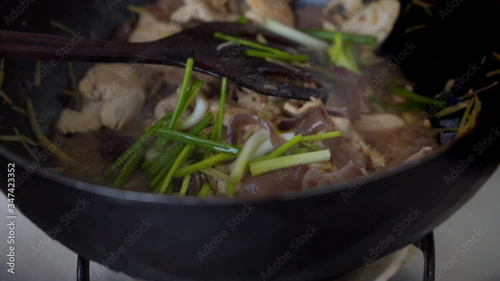 Closeup frying chicken cooking with vegetable ginger and mushroom in the pan, Thai street food , Slow motion Closeup frying chicken cooking with vegetable ginger and mushroom in the pan, Thai street food , Slow motion