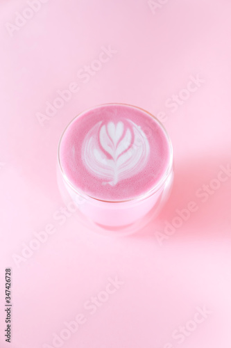 matcha latte with rosetta art on pink background copy space
