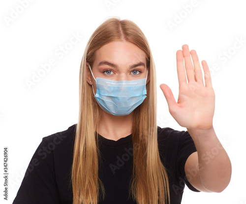 Girl wearing mask for protection from disease and show stop hands gesture for stop corona virus outbreak.