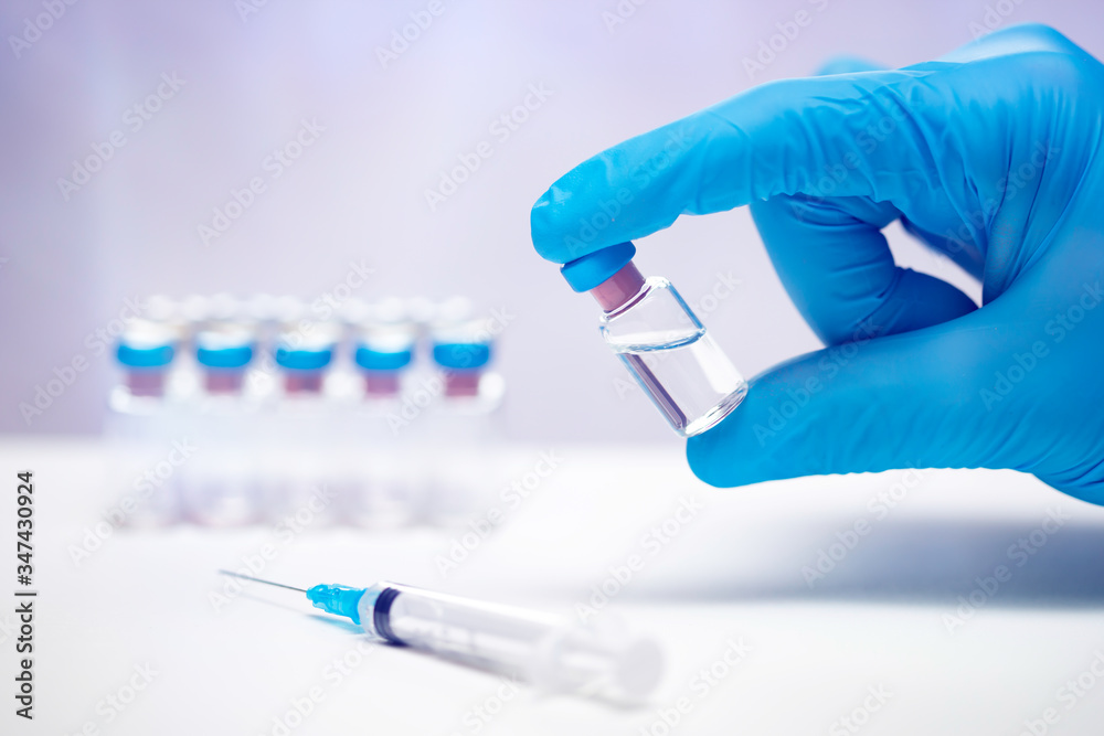 Close up on vaccine and medical syringe Close up on vaccine and medical syringe