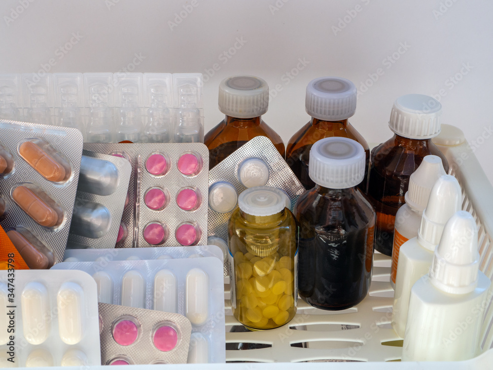 Medical background with medicines for pharmacies, hospitals, clinics. On the left are tablets in blisters, on the right are.glass and plastic bottles with liquid medicines. Medical background with medicines for pharmacies, hospitals, clinics. On the left are tablets in blisters, on the right are.glass and plastic bottles with liquid medicines.