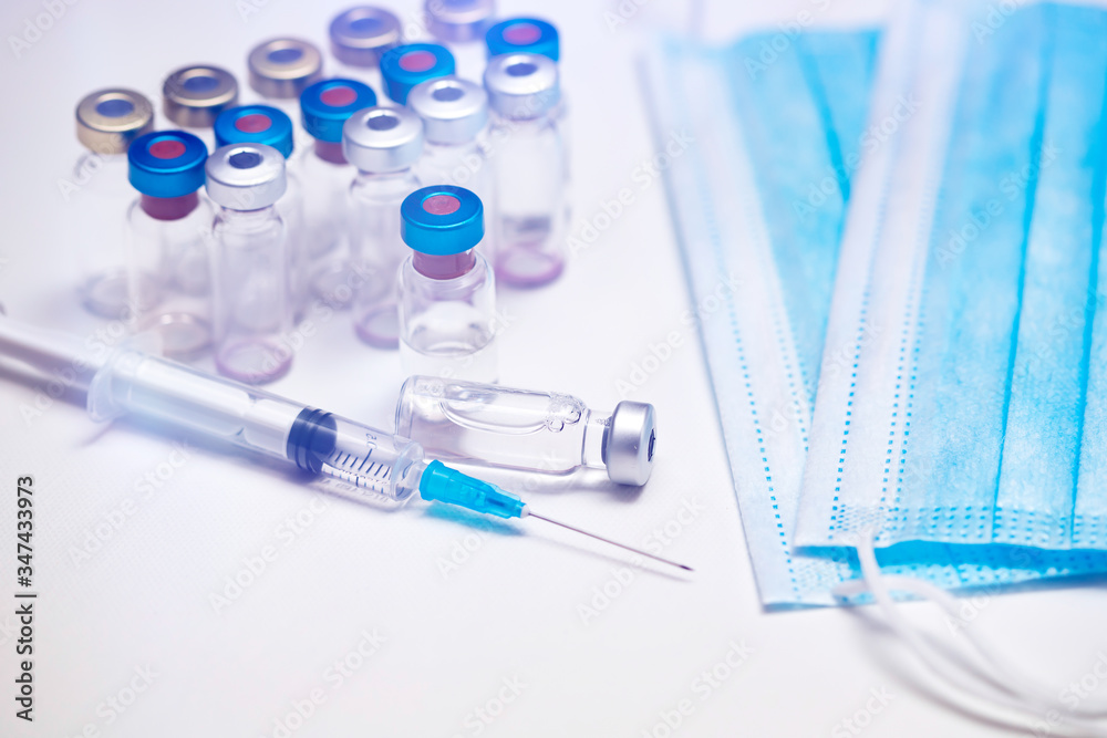 Close up on vaccine and medical syringe Close up on vaccine and medical syringe