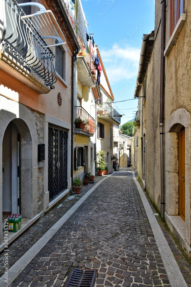 A narrow street between the old houses of the village of Pietraroja, in the province of Benevento, Italy