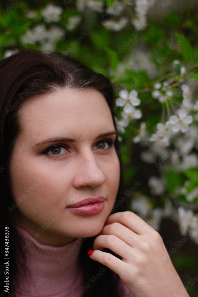portrait of a young girl in a blossoming apple tree portrait of a young girl in a blossoming apple tree