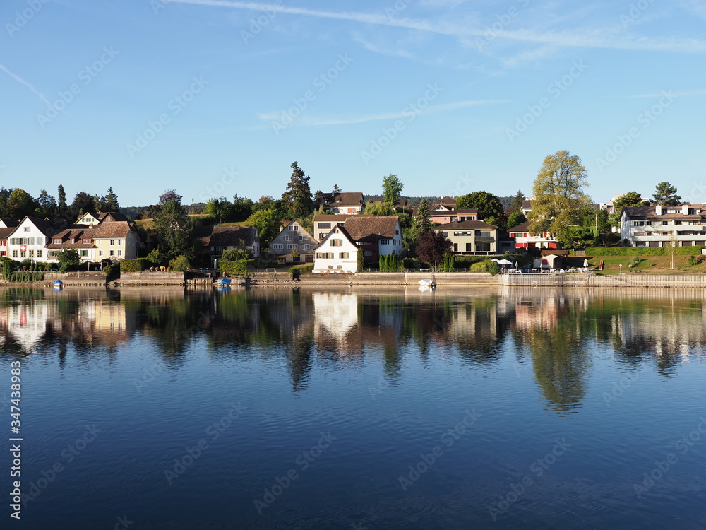 Houses reflected in Rhine River in STEIN am RHEIN town in Switzerland