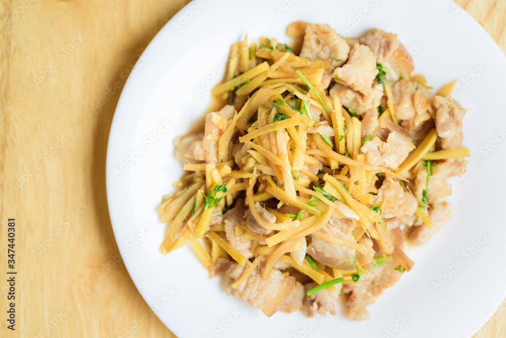 Stir fried pork with sliced ginger on white plate, Thai food Stir fried pork with sliced ginger on white plate, Thai food