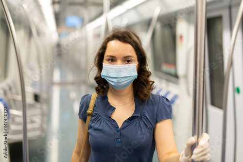 Travelers in protective equipment in a subway carriage