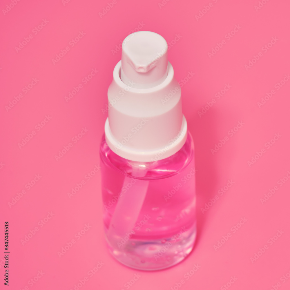 Sanitizer spray with pink liquid, hygiene product close-up. A means for washing hands in a pandemic coronavirus Sanitizer spray with pink liquid, hygiene product close-up. A means for washing hands in a pandemic coronavirus