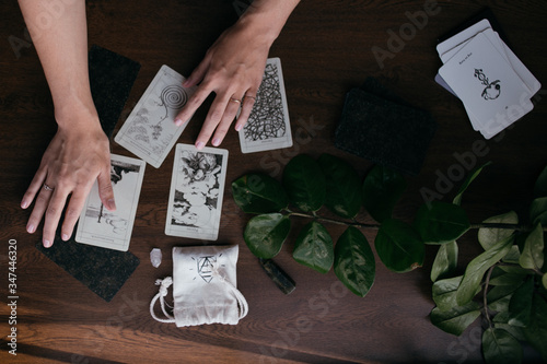 woman reading the tarot cards on the brown table