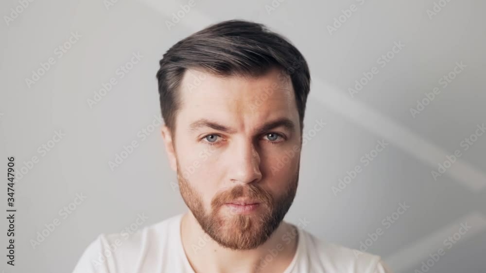 handsome man puts on his mustache handsome man puts on his mustache