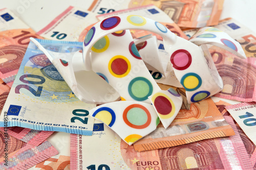 Shattered cup on top of euro bills symbolizing economic fallout due to coronavirus pandemic crisis.