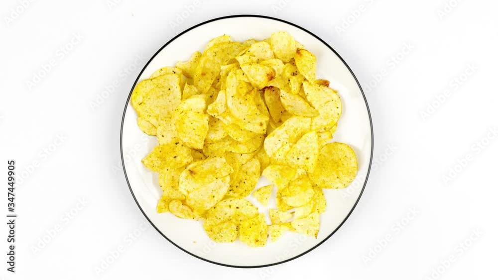 Stop motion of chips on plate while taken by a man Stop motion of chips on plate while taken by a man