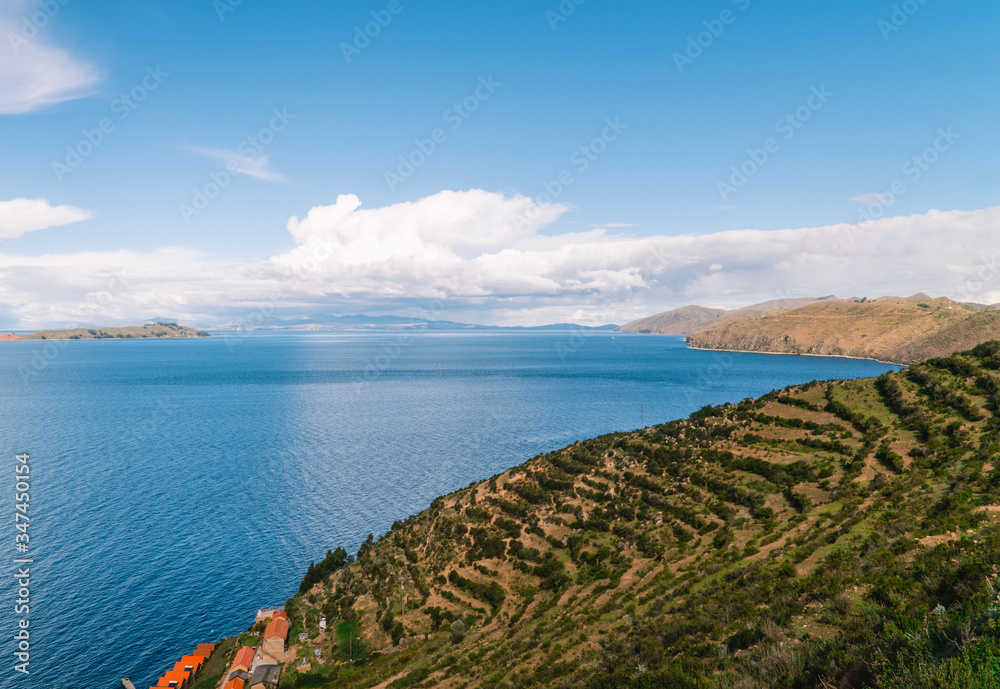 Lake water Island, Bolivia. Scenic panoramic view of island and sea horizon. Bolivian Isla del Sol island paradise and hills. Tourist walking trail, arrival by boat. Local community, tourism. Titicaca