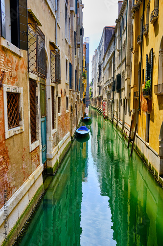 Lonely canal in Venice with two boats