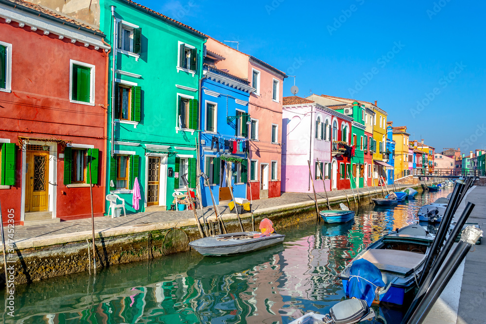 Colorful houses by a narrow canal in Burano