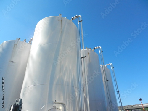 Large volume chemical external storage tanks against a blue sky background