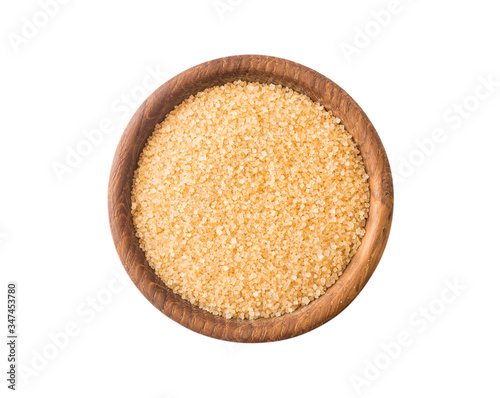 Heap of cane sugar isolated on white background. Top view. Heap of brown sugar on white background. Wooden bowl of dark sugar isolated on white background. Selective focus.