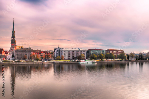 Skyline of Riga and the river Daugava in the morning, Latvia. St. Peter's Church (left). Delicate pink morning