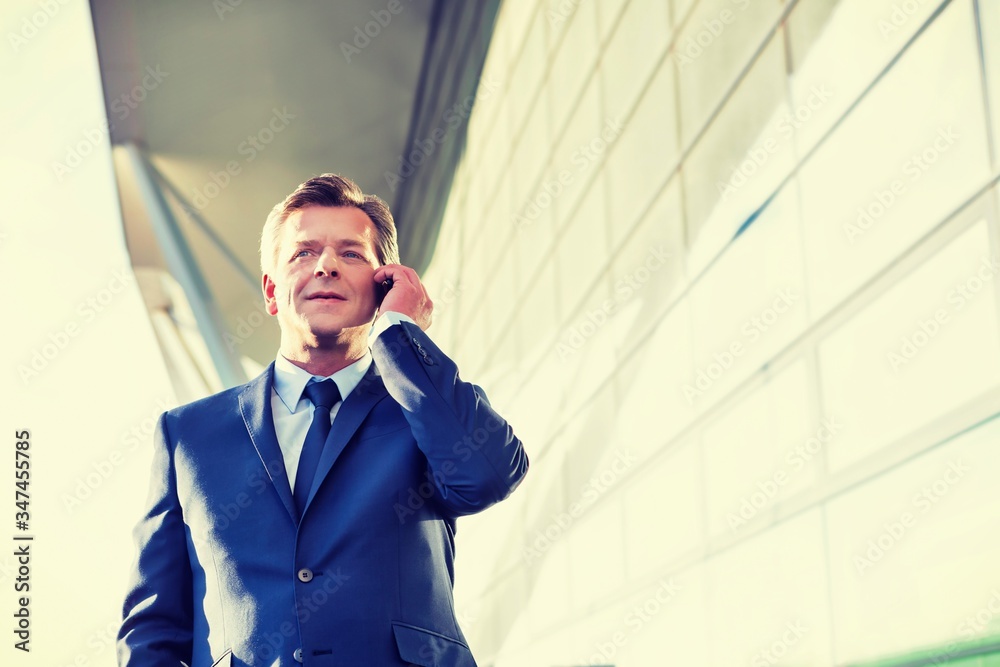 Portrait of businessman talking on smartphone in airport Portrait of businessman talking on smartphone in airport