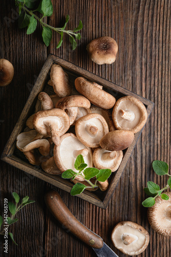 Heap of immunity boosting fresh Shiitake mushrooms in a bowl photo