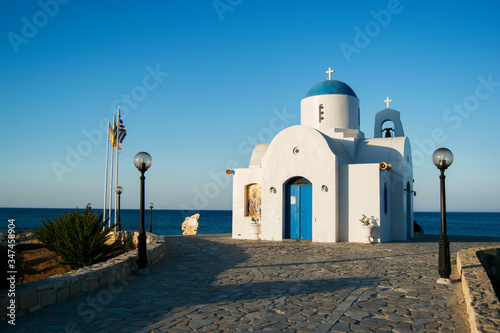 Church of St. Nicholas in Protaras, Cyprus at sunset against the background of the sea photo