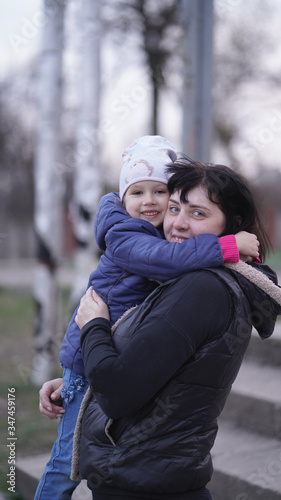 Beautiful Mom with cute little daughter on playground © www.akolosov.art 
