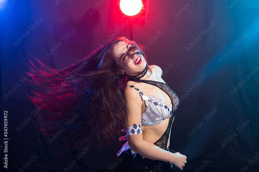 Naklejka premium Art portrait of a beautiful traditional female dancer. Ethnic dance. Belly dancing. Tribal dancing.