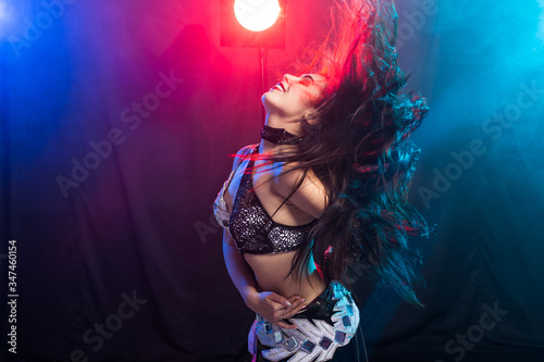 Portrait of a woman in oriental costume performing belly dance. Tribal fusion dance concept.