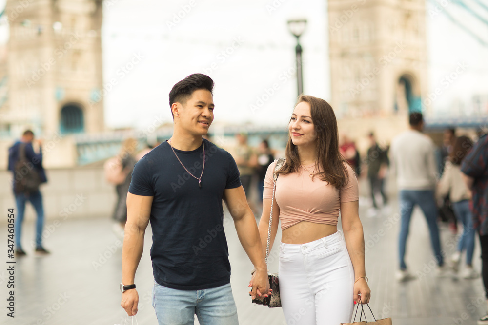 young couple walking together by tower bridge