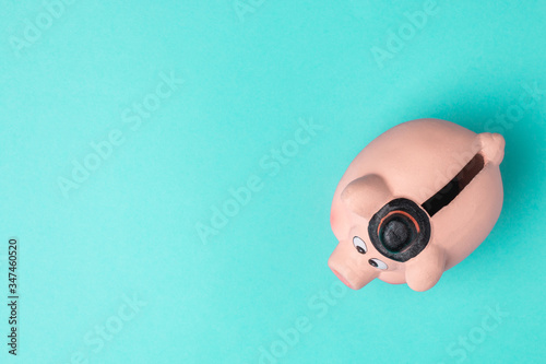 Piggy bank isolated on blue background with copyspace