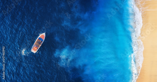 Fototapeta Naklejka Na Ścianę i Meble -  Seascape with beach and boat. Yachts at the sea surface. Aerial view of luxury floating boat on blue Adriatic sea at sunny day. Travel - image