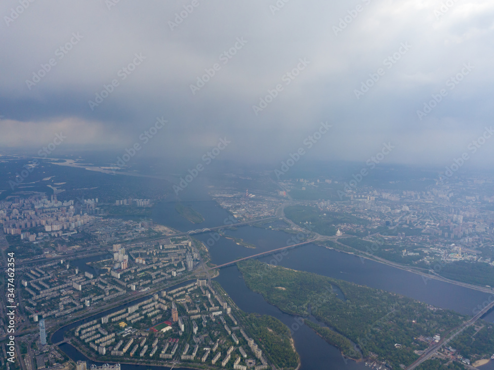 Spring rain over Kiev. There are black thunderclouds in the sky, dark rain falls on the city. Aerial drone view.
