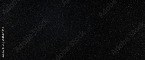 Panoramic black granite surface. Texture background for graphic applications