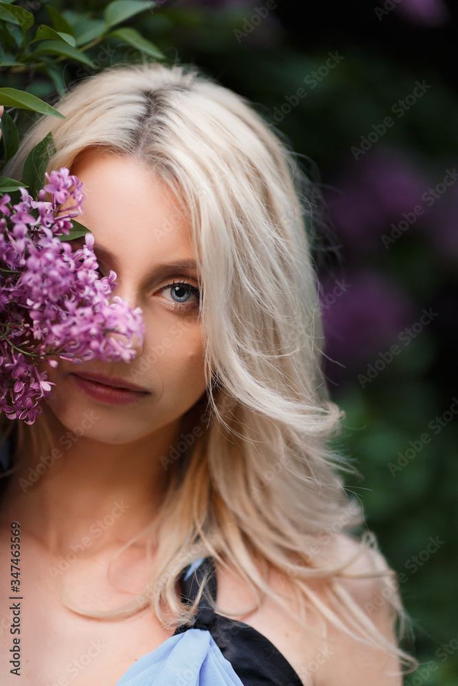 Beautiful adult woman in a flowering lilac Beautiful adult woman in a flowering lilac
