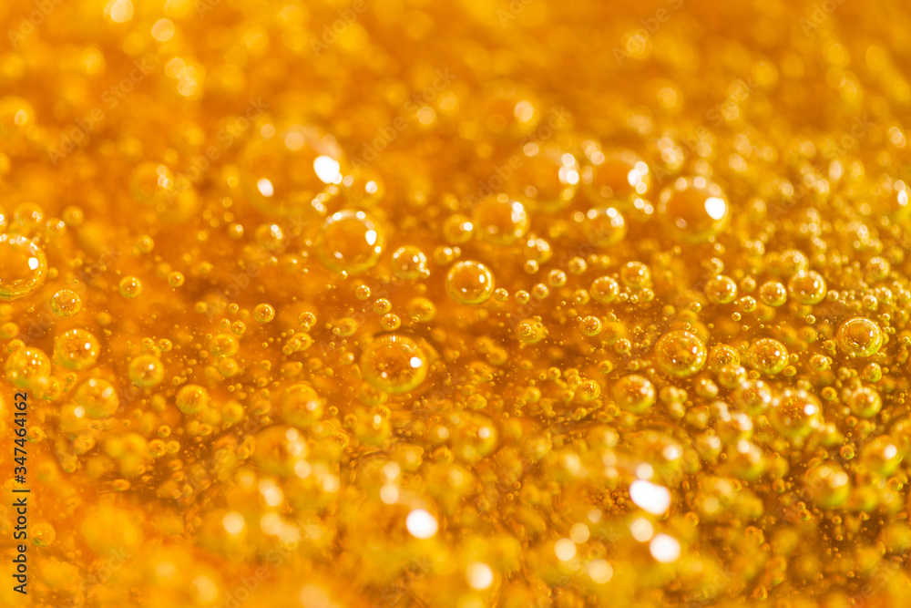 Detail of abstract orange bubble, can be used for background. Paste for sugaring close-up. Depilation and hair removal concept. Macro photo. Detail of abstract orange bubble, can be used for background. Paste for sugaring close-up. Depilation and hair removal concept. Macro photo.