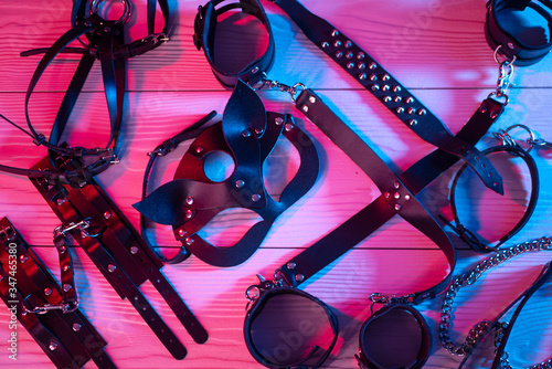 Set of erotic toys for BDSM. The game of sexual slavery with a whip, gag and leather blindfold. Intimate sex games photo