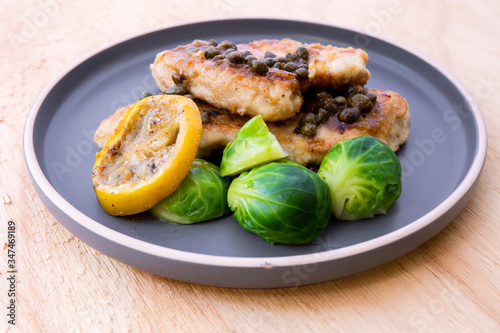 Italian food Lemon chicken Piccata with Brussels Sprouts