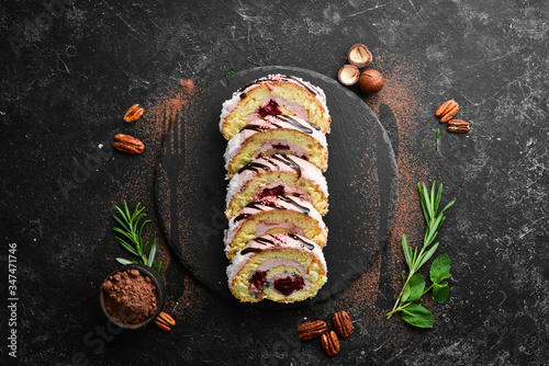 Sweet cake roll with cream and cherries. Top view. Free space for your text.