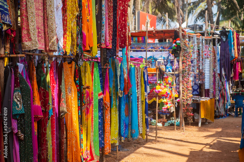 Photography Indian bazaar benches with colorful saris