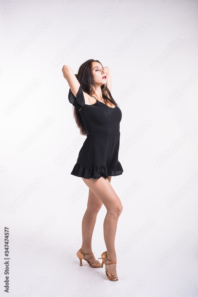 Latina dance, strip dance, contemporary and bachata lady concept - Woman dancing improvisation and moving her long hair on a white background. Latina dance, strip dance, contemporary and bachata lady concept - Woman dancing improvisation and moving her long hair on a white background.