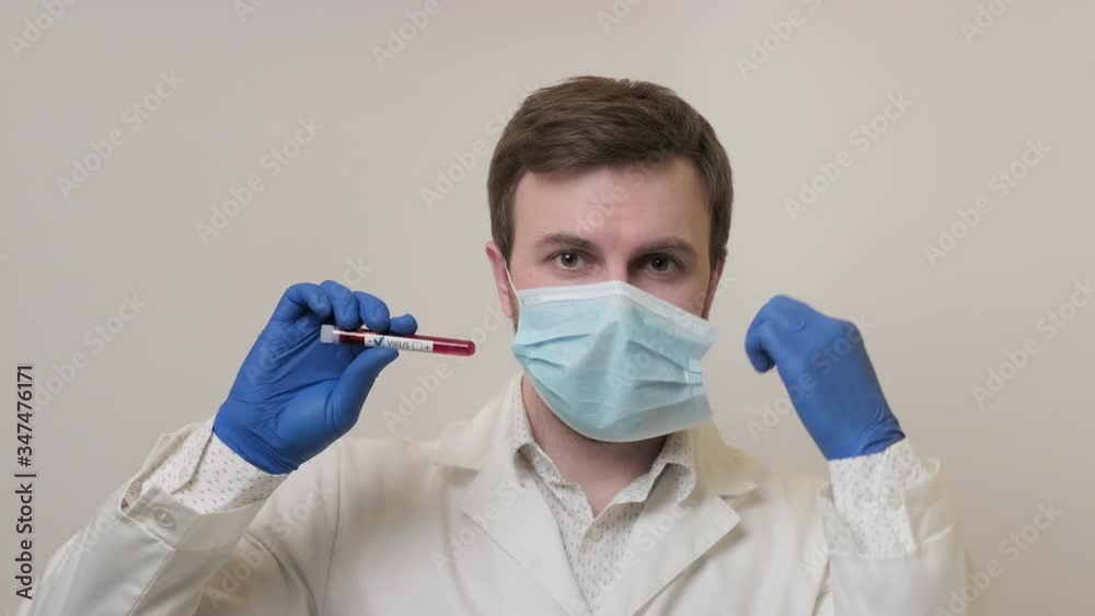 Doctor shows negative result of virus test and takes off protective glasses and mask at white background. Smiling microbiologist at USA flag. Blood test. Virus concept in 4K, UHD Doctor shows negative result of virus test and takes off protective glasses and mask at white background. Smiling microbiologist at USA flag. Blood test. Virus concept in 4K, UHD