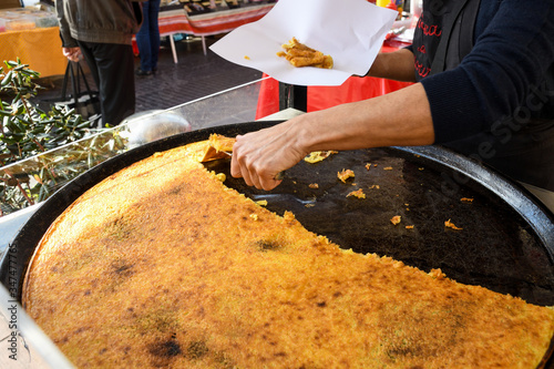 Nice, France, 25th of February 2020: Farinata or Cecina or Torta di ceci thin unleavened pancake